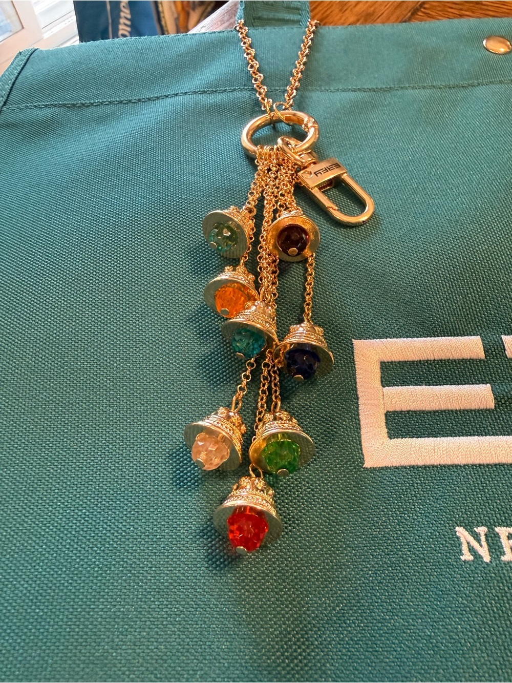 Effy Teal Canvas Logo Tote with Gold color bag charm with 8 Effy bell charms.